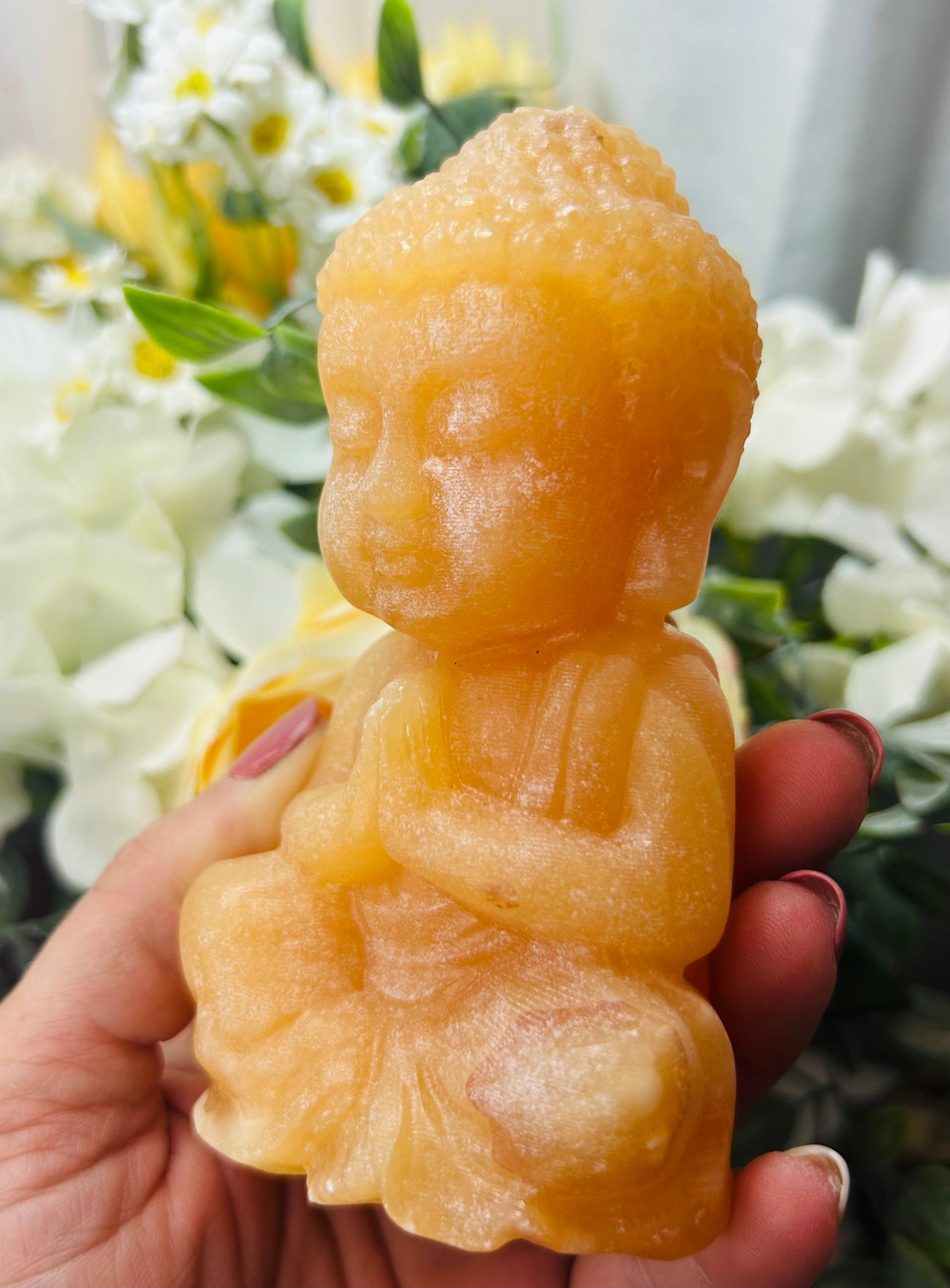 Orange calcite Buddha