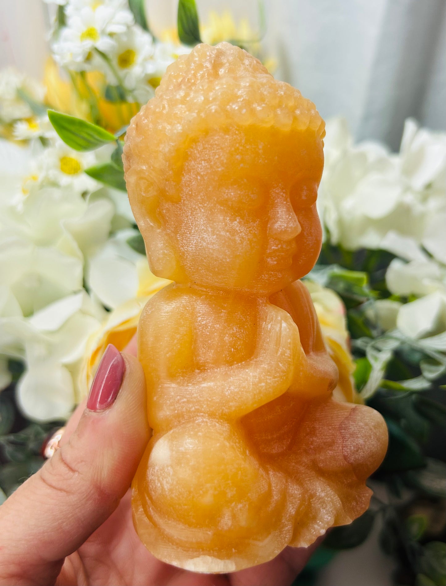 Orange calcite Buddha