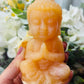 Orange calcite Buddha